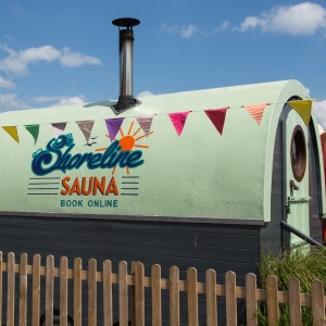 Shoreline Sauna in Lyme Regis, brightly painted logo on the side